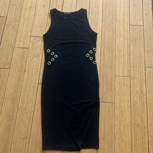 Black dress with gold rings that show off skin with a side slit. SIZE S.